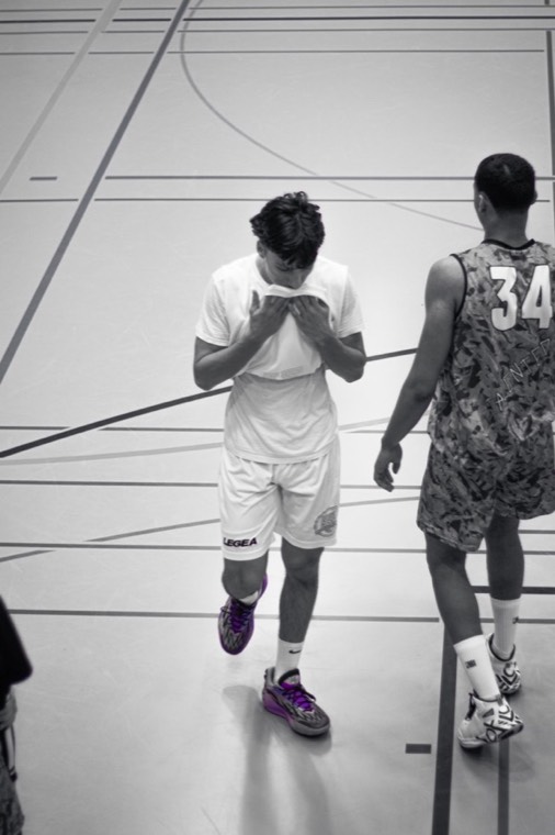 Black-and-white photo walking off the court during a Baden game