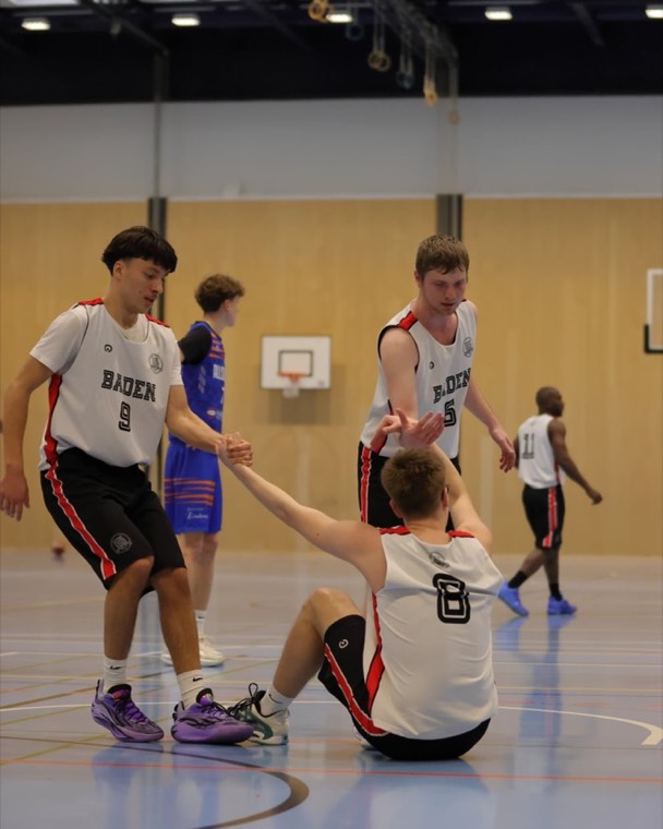 Helping teammate #8 off the floor during a Baden game