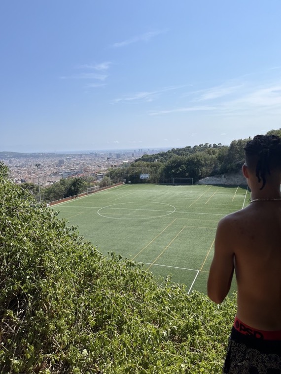 Looking over a football pitch and a city by the sea