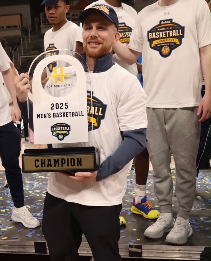 Blake Kingsley Junior holding the 2025 Horizon League men's basketball championship trophy